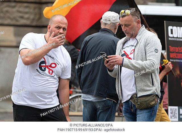 15 July 2019, Saxony, Dresden: Siegfried Däbritz (l) and Lutz Bachmann, founder of the xenophobic Pegida alliance, stand in front of the Albertinum on the...