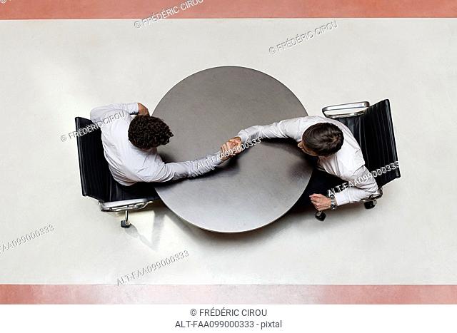 Businessmen arm wrestling