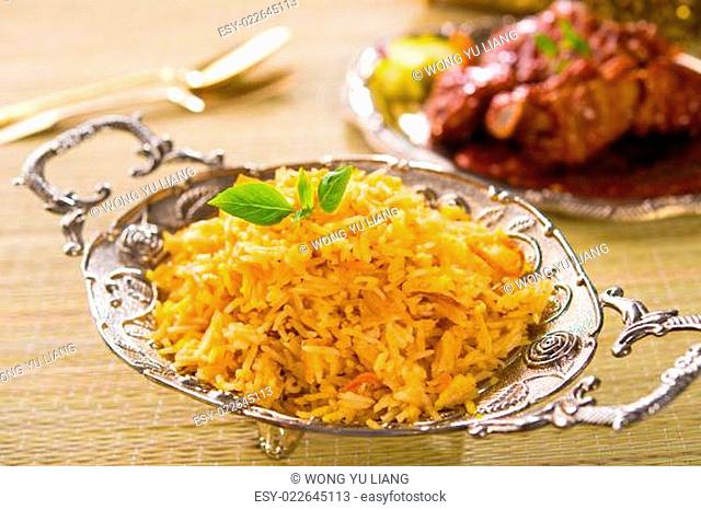Biryani rice or briyani rice, curry chicken and salad, traditional indian food on dining table