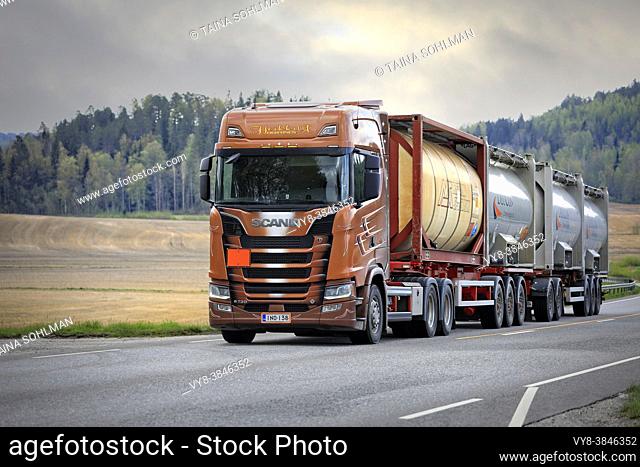 Scania S730 truck of AH-Trans Oy hauls four chemical tank containers on road, ADR codes denoting Sodium. Long transport. Salo, Finland. May 15, 2021