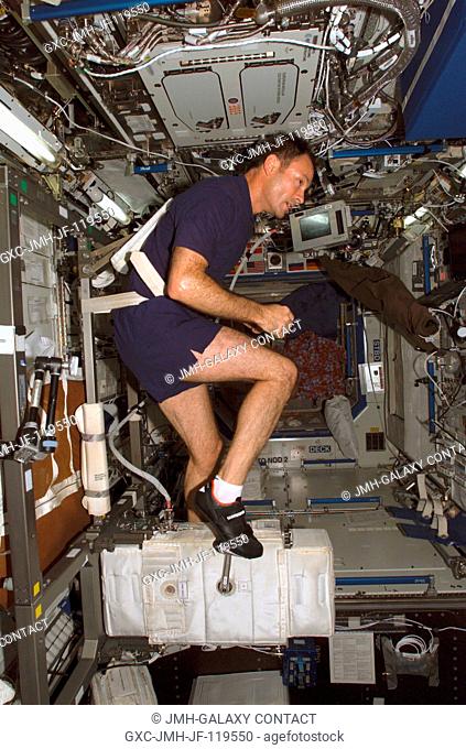 Astronaut Michael E. Lopez-Alegria, Expedition 14 commander and NASA space station science officer, exercises on the Cycle Ergometer with Vibration Isolation...