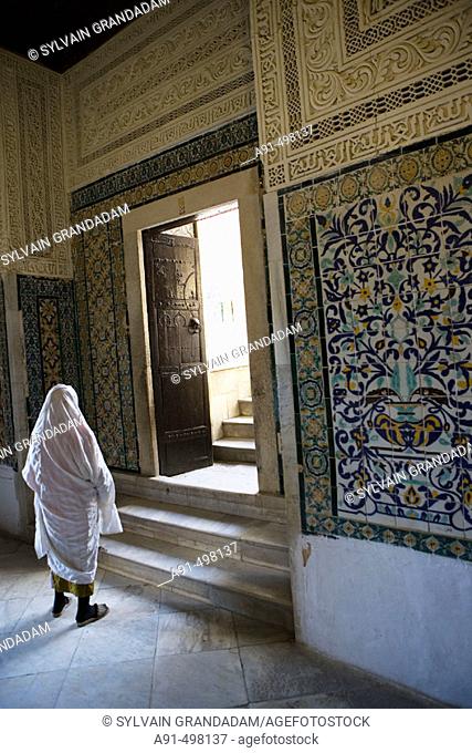 Woman asking the saint to grant a favour in Abou Dhama (companion of the prophet Mohammed) Zaouia  (mausoleum) .  Kairouan. Tunisia