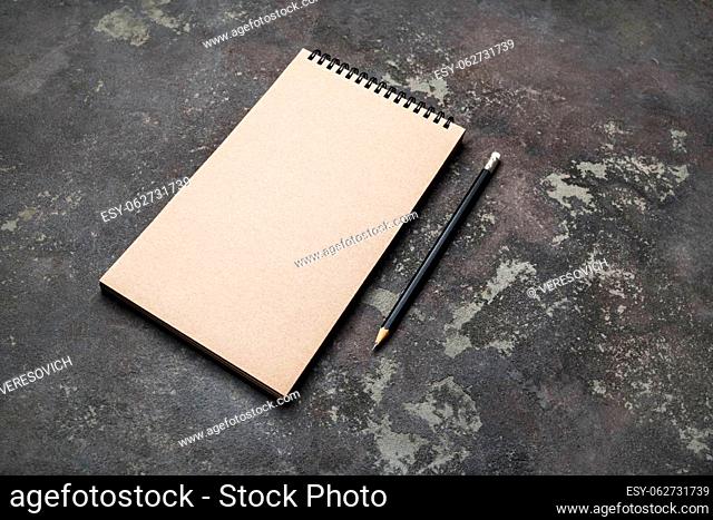 Photo of blank kraft sketchbook and pencil