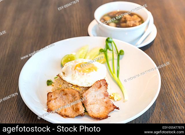 Fried rice with grilled pork and fried egg served with bak kut teh soup