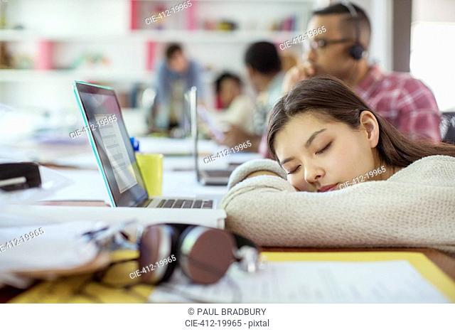 Woman sleeping at conference table