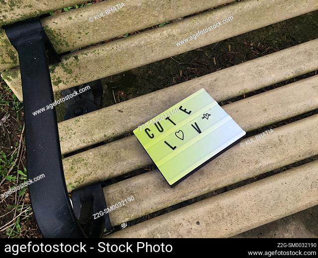 A cryptic message of love on a park bench, Ontario, Canada. Or a broken piece of equipment left behind To whom it may concern