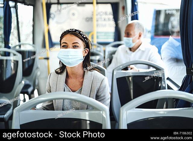 Young woman in protective mask traveling in the bus in Faro, Portugal, Europe