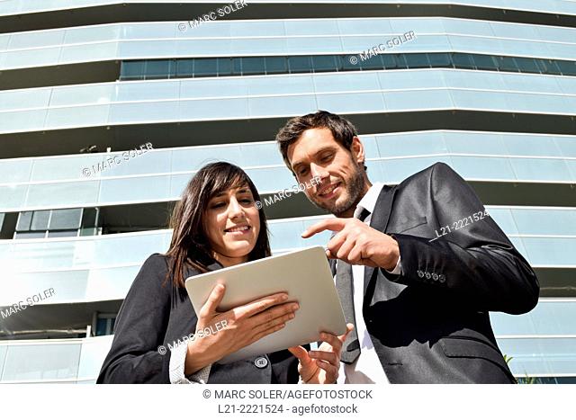 Business man and business woman with tablet