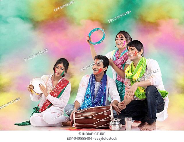 Friends playing music during holi