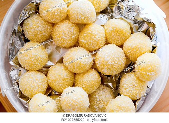 Home made raffaello coconut candy balls in ceramic bowl ready to be served on Saints day