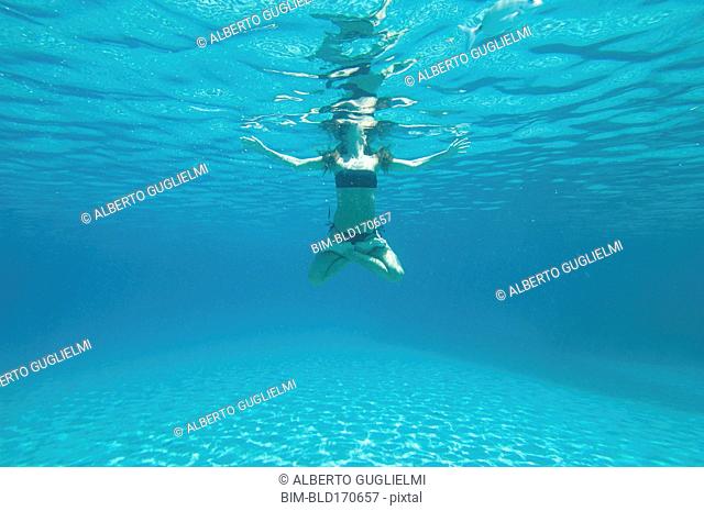 Underwater view of woman swimming in ocean