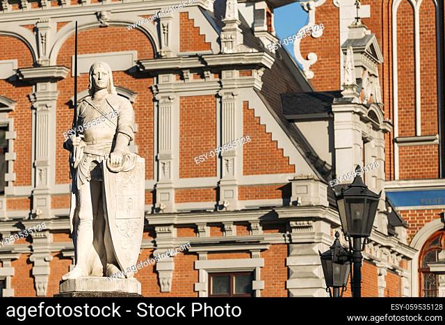 Riga, Latvia. Statue Of Roland At Town Hall Square. House Of Blackheads. Sunny Summer Day With Blue Sky. Famous Landmark. Old Architecture