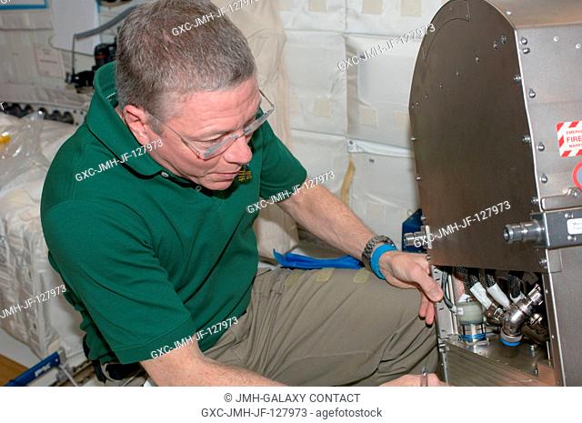 NASA astronaut Mike Fossum, Expedition 28 flight engineer, works with Muscle Atrophy Research Exercise System (MARES) hardware in the Columbus laboratory of the...