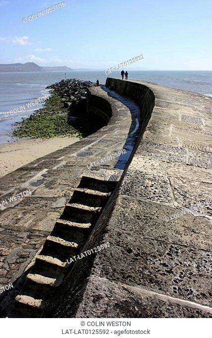 Lyme Regis is an historic unspoiled seaside resort and fishing port surrounded and protected by the sturdy historic Cobb harbour wall
