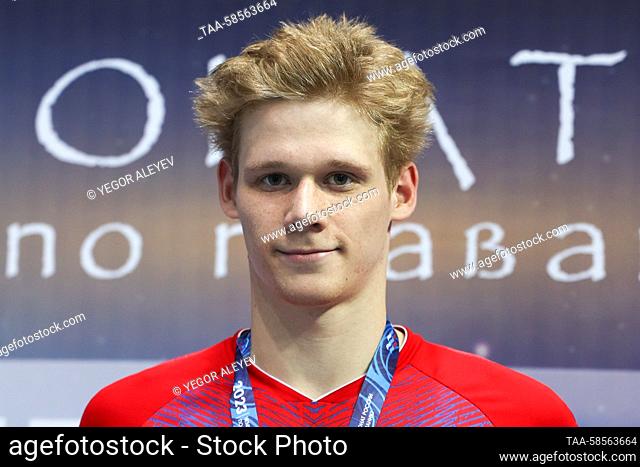 RUSSIA, KAZAN - APRIL 21, 2023: Gold medalist Alexander Stepanov poses during an award ceremony for the men's 1, 500m freestyle final at the 2023 Russian...
