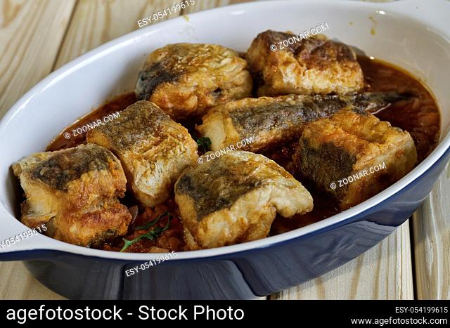Mediterranean cooking. Baked fish in tomato sauce