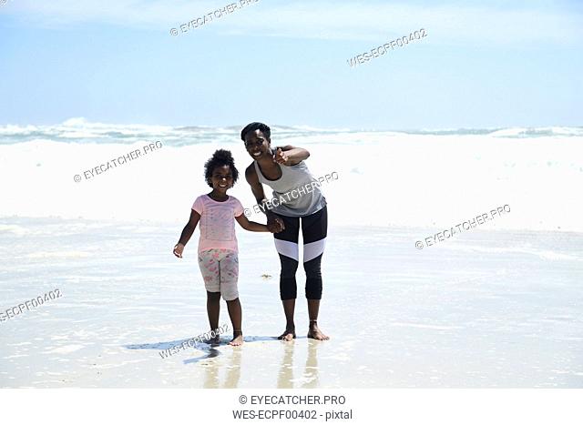 Mother with daughter on the beach