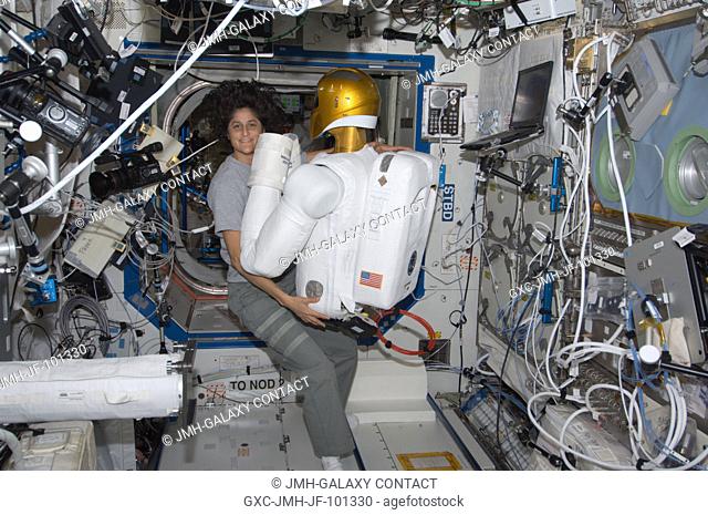 NASA astronaut Sunita Williams, Expedition 32 flight engineer, works with Robonaut 2 humanoid robot in the Destiny laboratory of the International Space Station