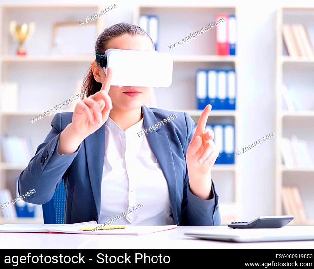 The businesswoman with virtual reality glasses in office
