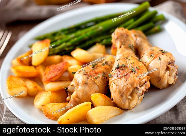 Roast chicken with potatoes and asparagus. High quality photo