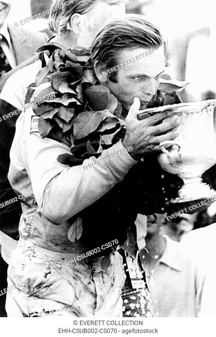 Peter Revson drinks from his trophy after winning the Canadian-American championship. Watkins Glenn, NY, July 25, 1971. He averaged a speed of 128