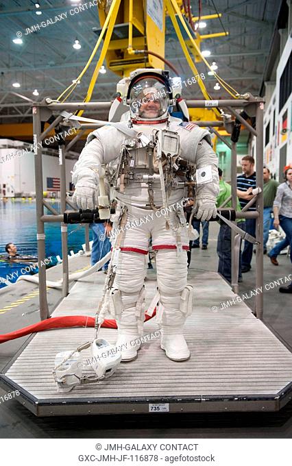 Attired in a training version of his Extravehicular Mobility Unit (EMU) spacesuit, NASA astronaut Rex Walheim, STS-135 mission specialist