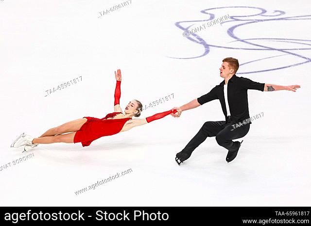 RUSSIA, CHELYABINSK - DECEMBER 21, 2023: Pair skaters Natalya Khabibullina and Ilya Knyazhuk perform a death spiral during a pairs' short programme event as...