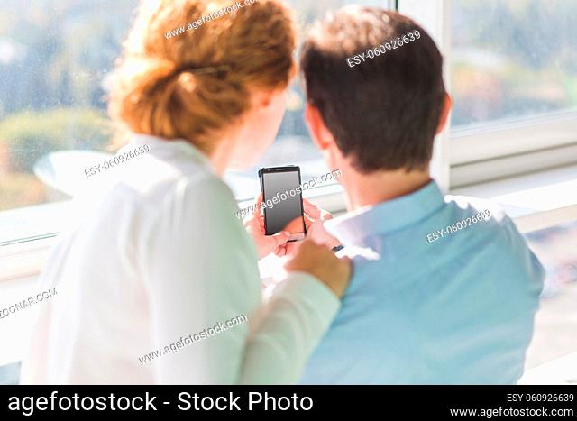 Business people making photos on mobile or smart phone. Happy couple resting during working time. Business concept. Break. Photo concept