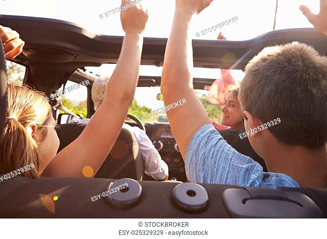 Grandparents Taking Grandchildren On Trip In Open Top Car