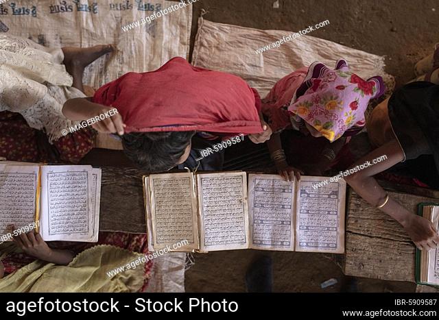 Girls reading in a madrasah, Koran school, camp for Rohingya refugees from Myanmar, Kutupalong, Cox Bazar, Bangladesh, Asia