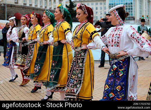 Sofia, Bulgaria - April 19, 2021: People in traditional folk costumes perform the Bulgarian folk dance