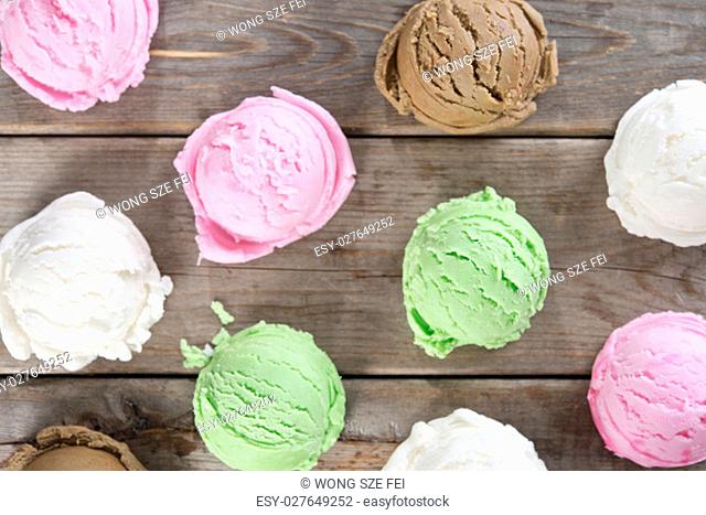 Top view ice cream scoops collection on brown rustic wooden background