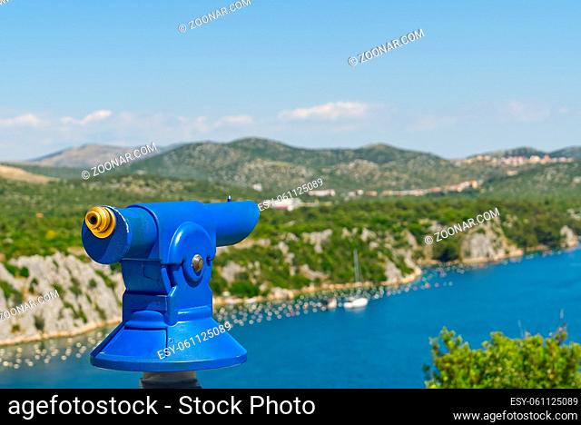 man using a panoramic telescope looking at the Mediterranean sea. Traveler exploring Adriatic sea landscape true panoramic telescope, Shebeinik, Croatia