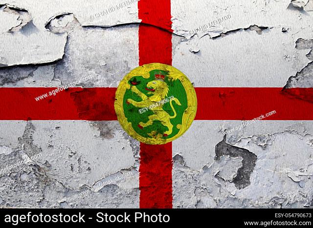 Alderney flag painted on the cracked grunge concrete wall