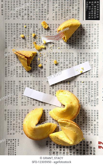 Fortune cookies, three whole and one smashed open