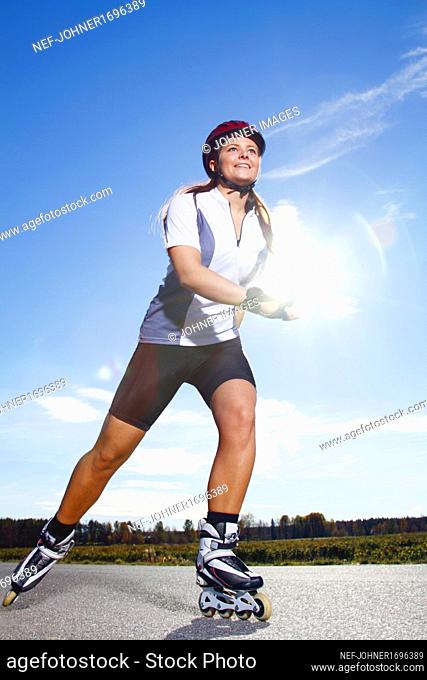 Smiling woman on rollerblades