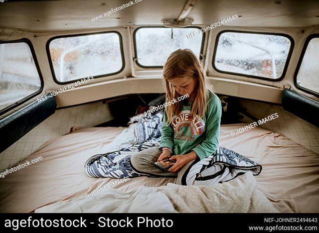 Girl on boat using cell phone