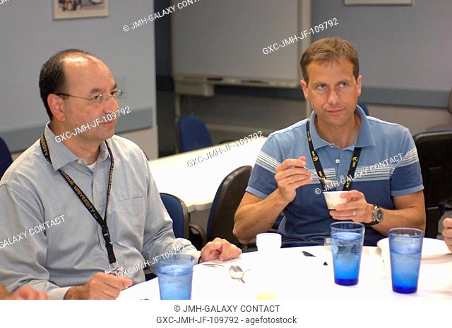 Astronauts Mark L. Polansky (left) and Thomas H. Marshburn, STS-127 commander and mission specialist, respectively, participate in a food tasting session in the...