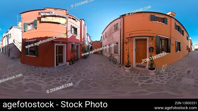 360 photo - Paved alleyway between typical coloured houses of Burano island. Two-storey houses with shutters