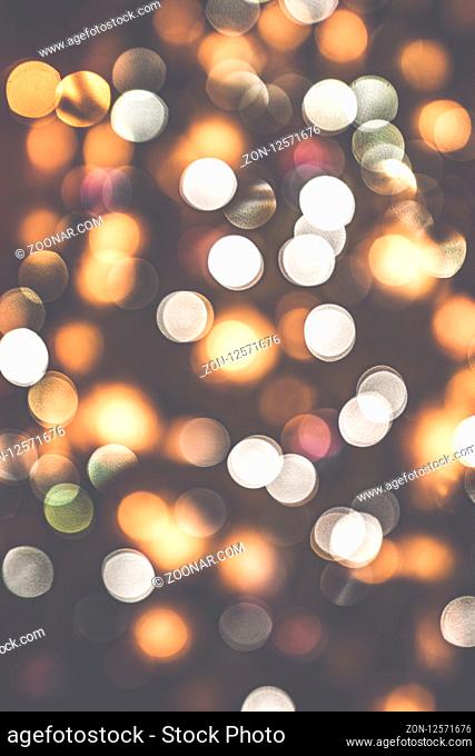 Retro bokeh lights on a dark background with glittering blurs in various colors
