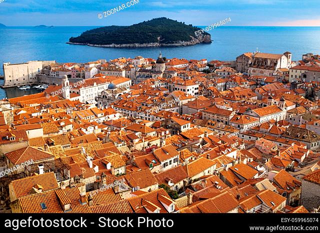 Panorama view of the mediterranean old town of Dubrovnik with orange tiled roofs and view on ocean and island Lokrum, Croatia