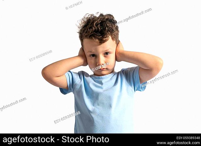 Young boy with his hands on his ears, isolated on white background