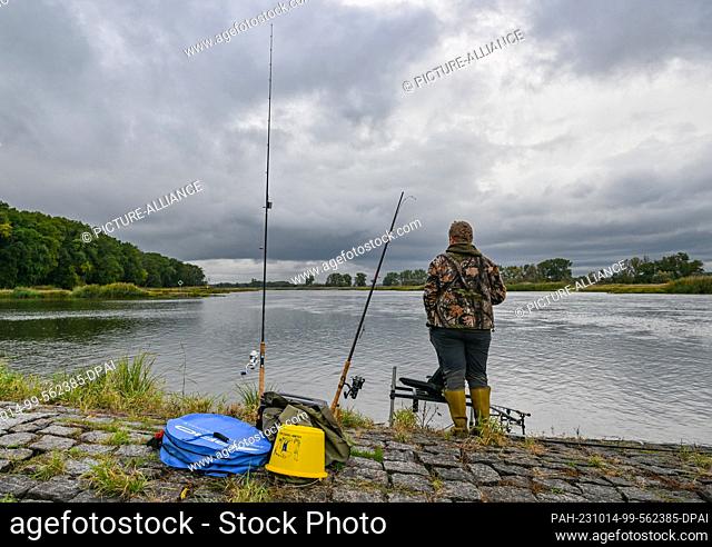 14 October 2023, Brandenburg, Brieskow-Finkenheerd: An angler stands on a groyne at the project day ""Fishing for Science on the Oder""