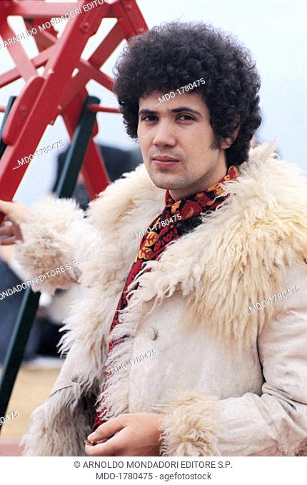 Lucio Battisti wearing a white sheepskin coat. Italian singer-songwriter Lucio Battisti wearing a white sheepskin coat during 19th Sanremo Music Festival