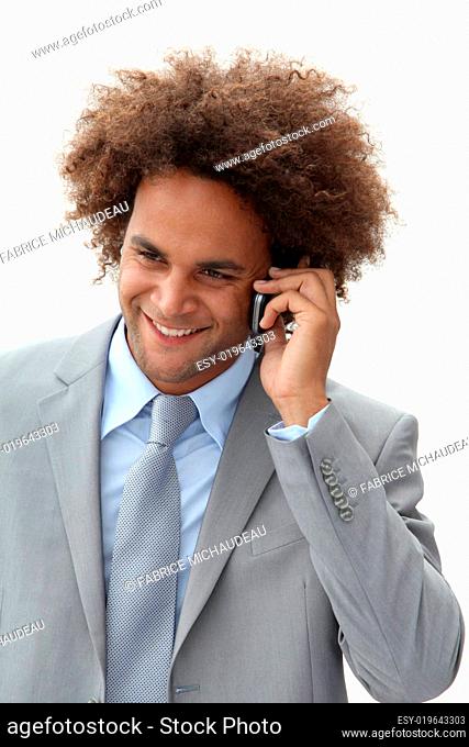Closeup of happy young businessman on the phone