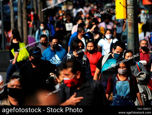 MEXICO CITY, MEXICO - DECEMBER 18, 2020: Persons wears protective masks while make christmas shopping at Historic Center