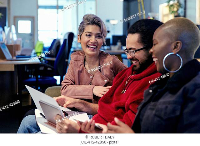 Laughing creative business people working in office