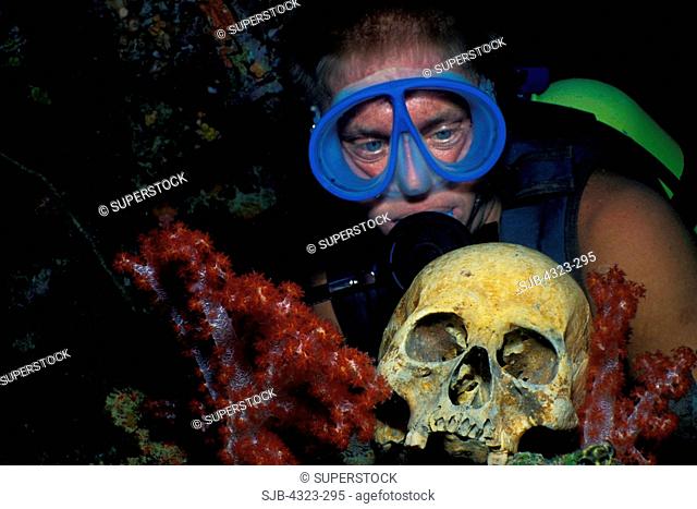 Scuba Diver Gazes at Human Skull on Wreckage, Truk Lagoon, Micronesia