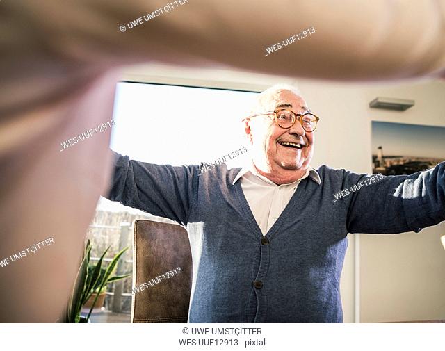 Happy senior man with outstretched arms