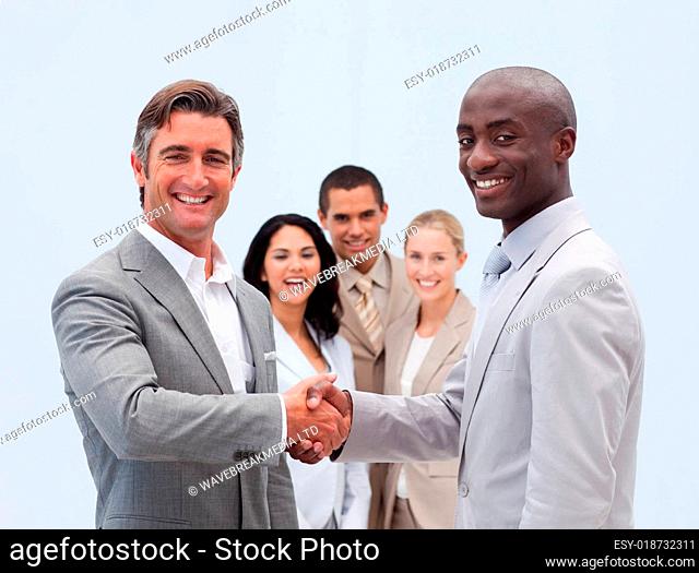 Caucasian and Afro-American businessmen shaking hands